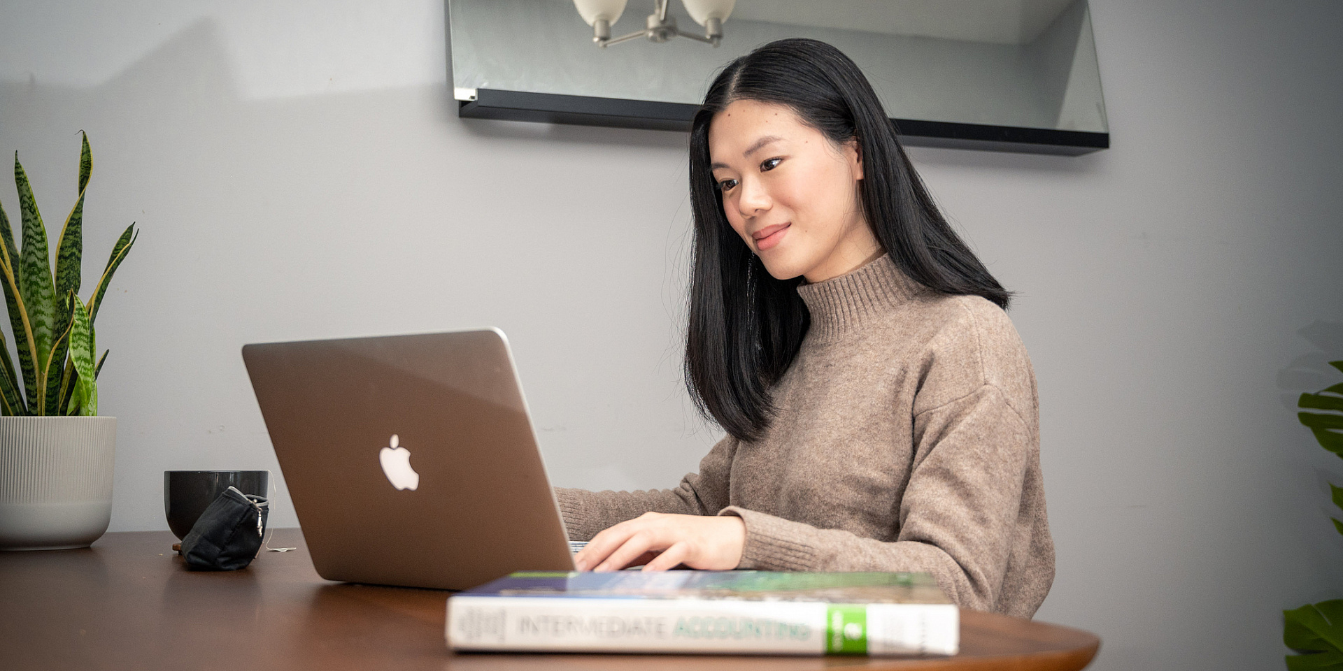 Telfer student working from home on her dining table