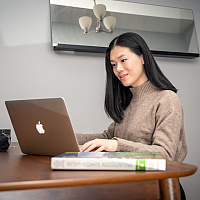 Telfer student working from home on her dining table