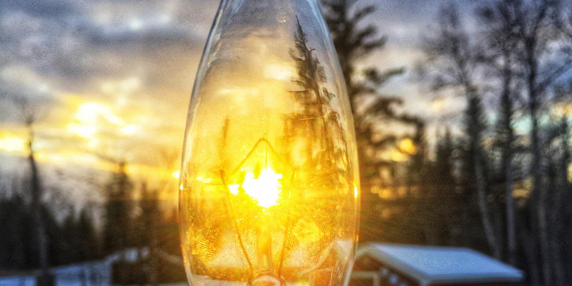 Light bulb with sun on backgound