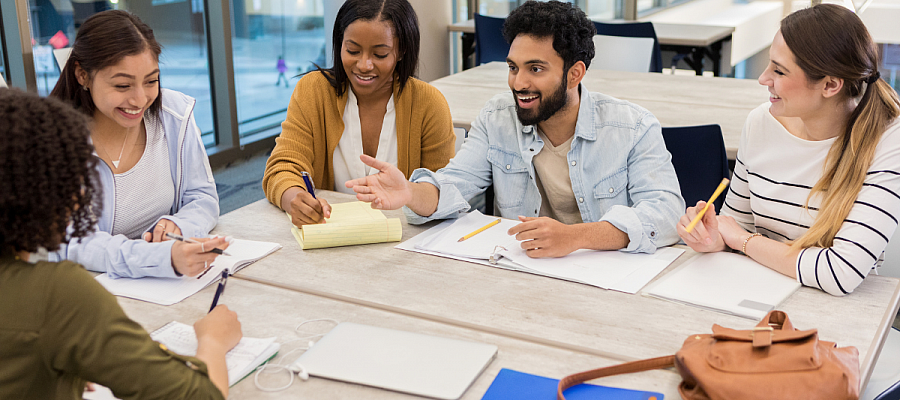 Diverse group of students discuss around a table