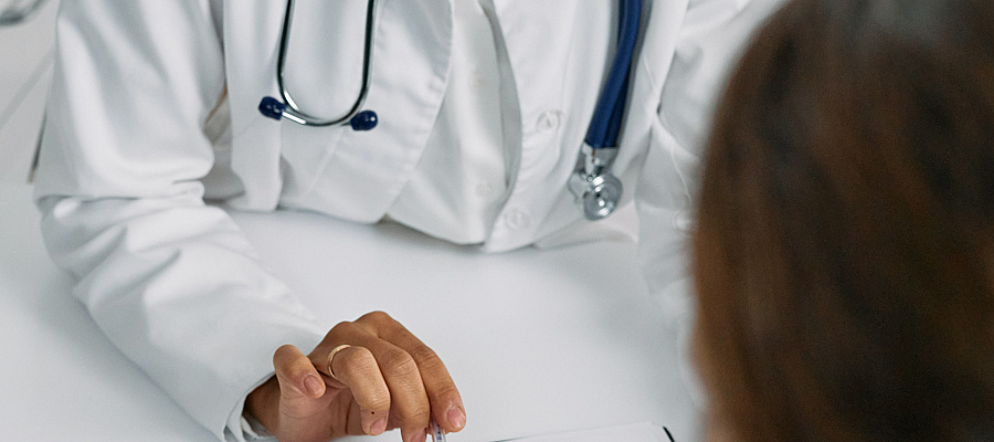 a member of the health system explains a document to a patient