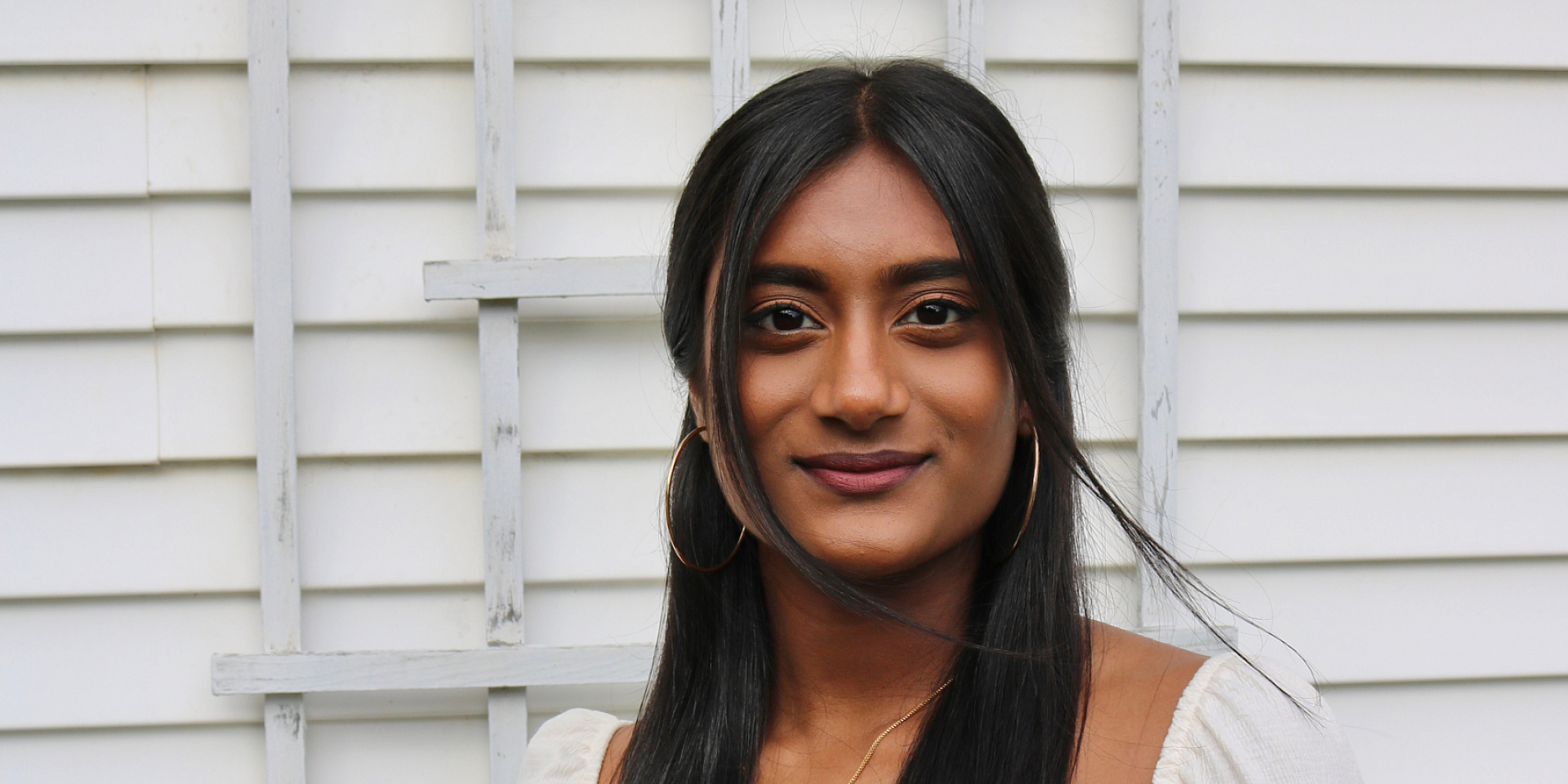 Headshot of Rivetha Kandeepan in front of a white wall.