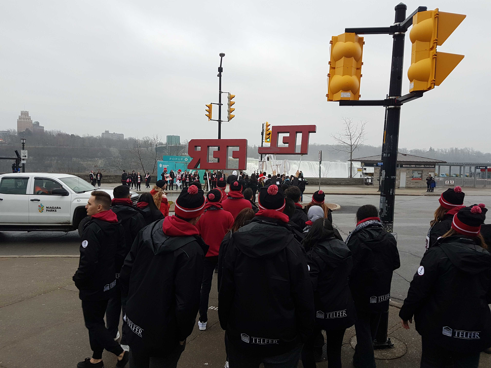 students walking with telfer sign at jdc outside