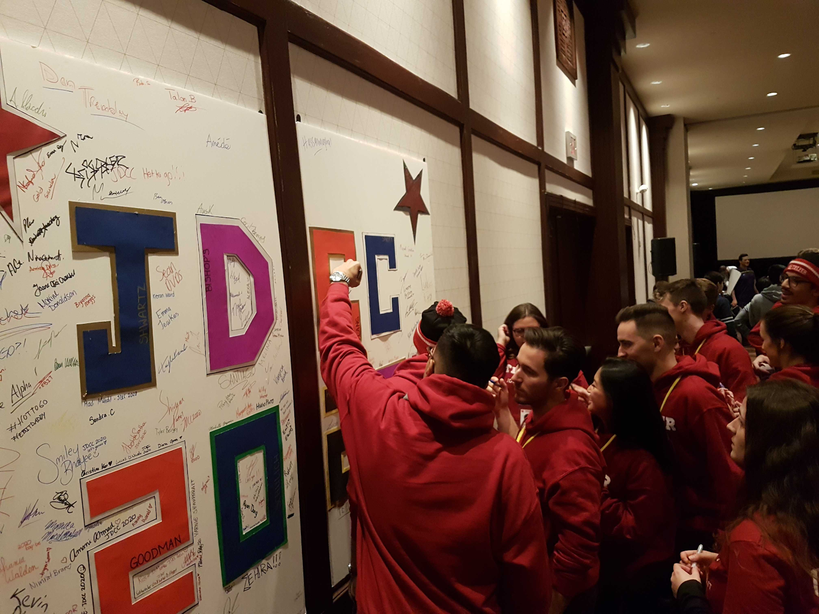 jdcc students writing on a poster