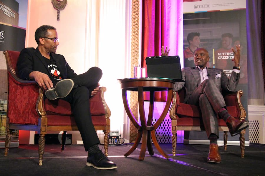 Wes Hall speaking on stage next to Dean Stephane Brutus at the Entrepreneur’s Club 31st annual Toast of Succes Dinner