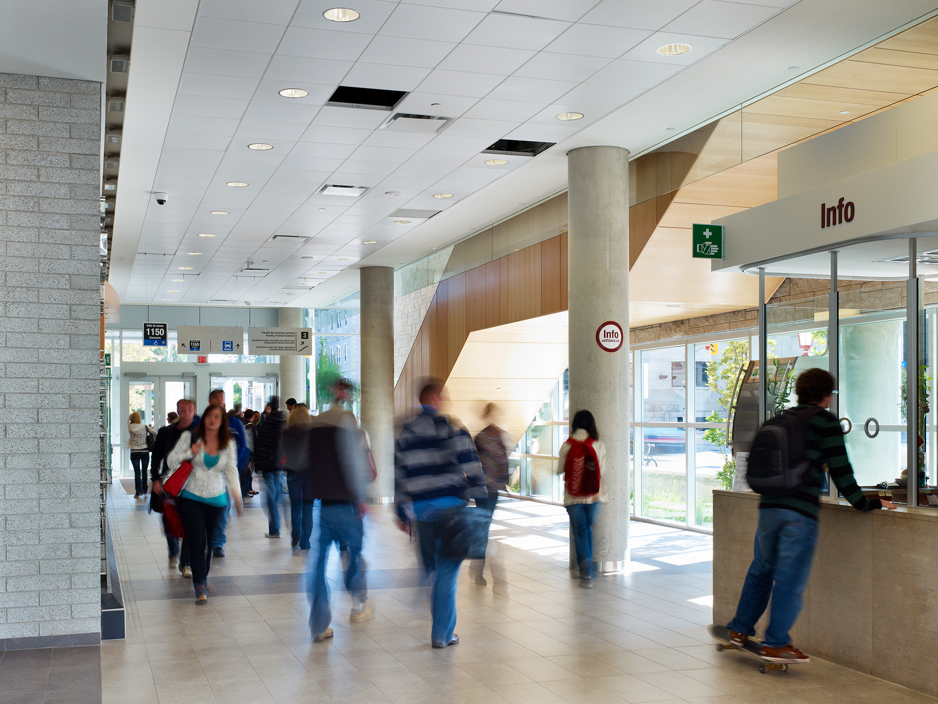 Telfer students walking through the Desmarais Building lobby.