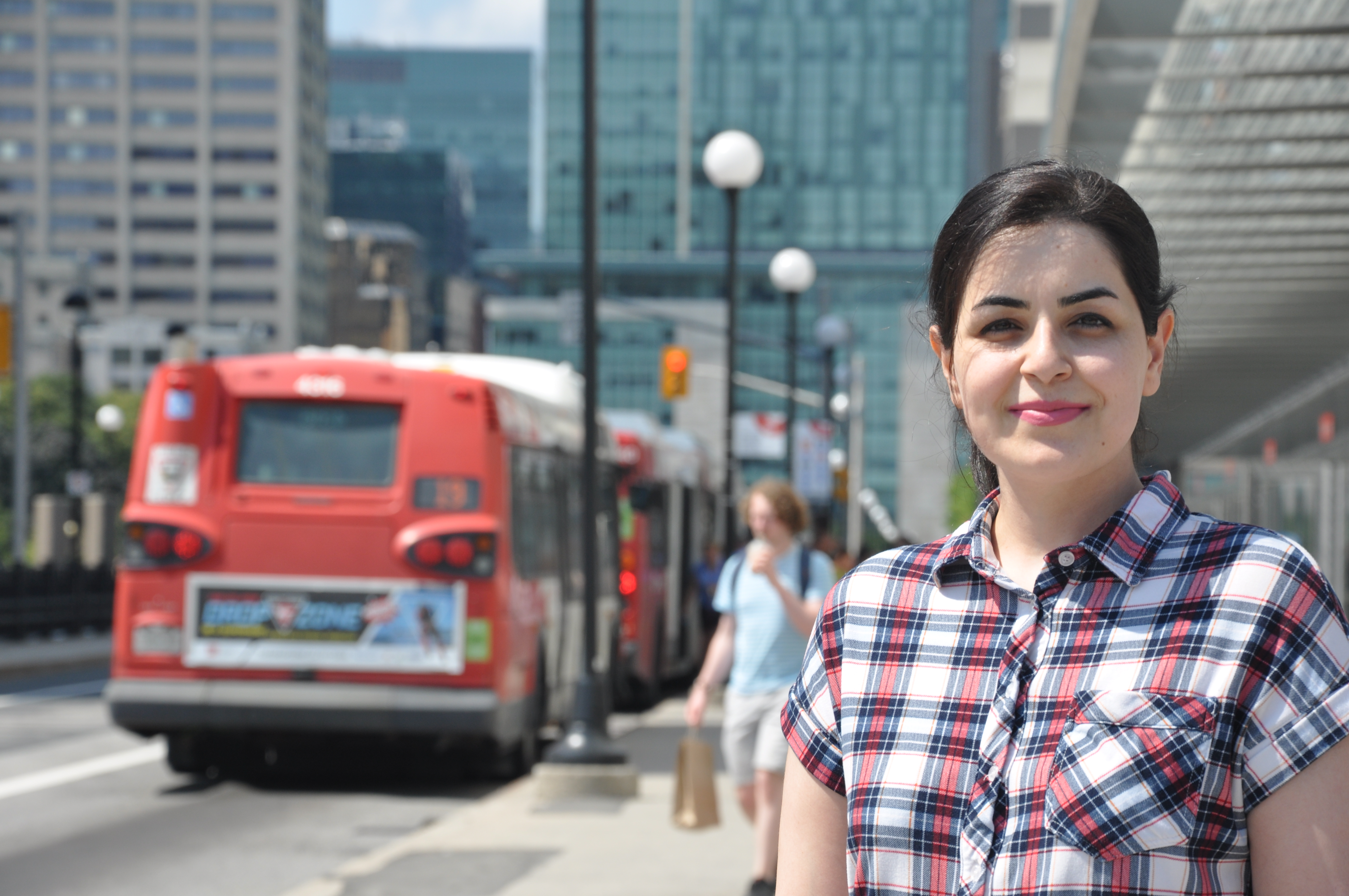 student in front of bus stop