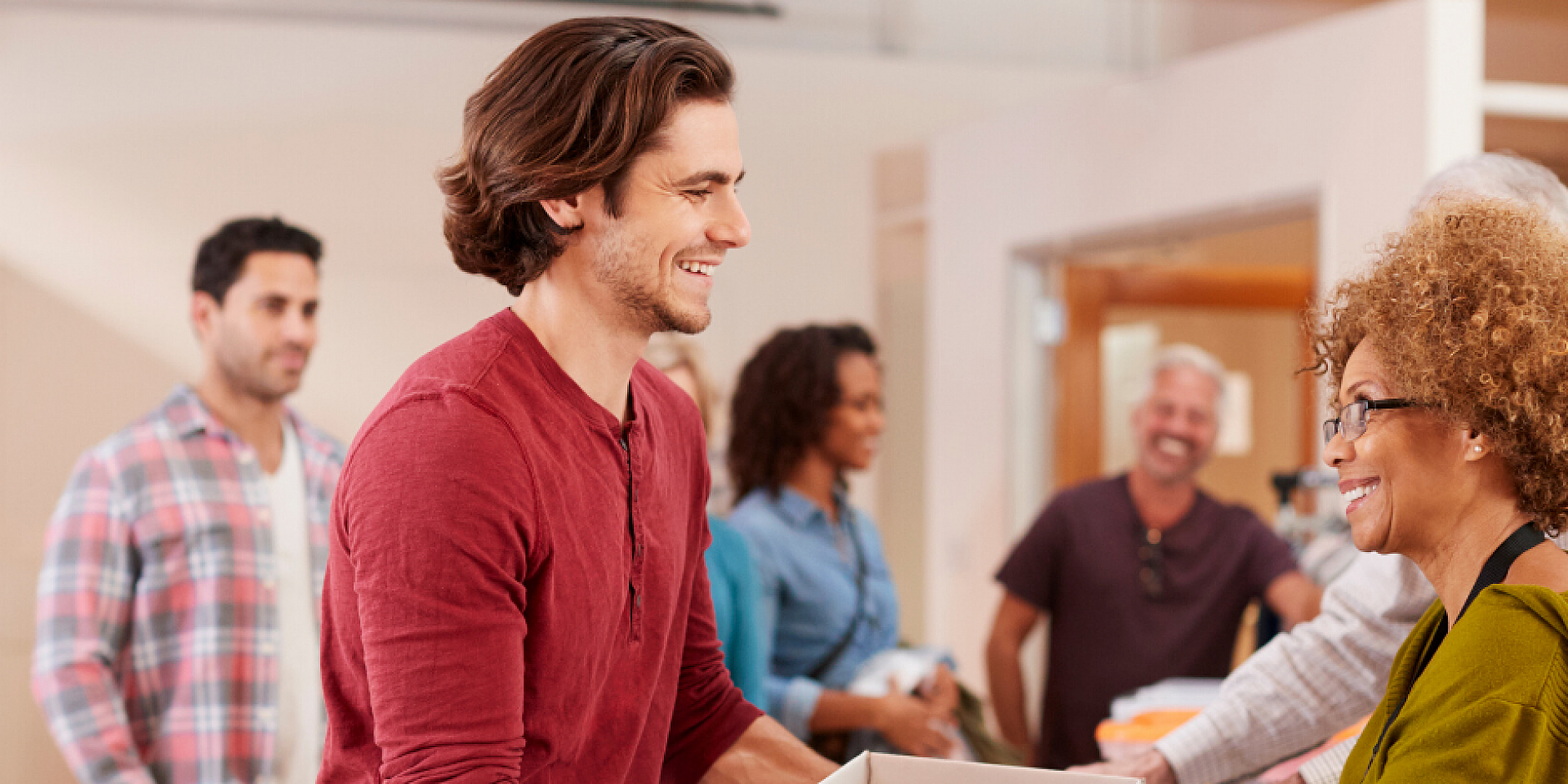 Man and woman smiling inside a building