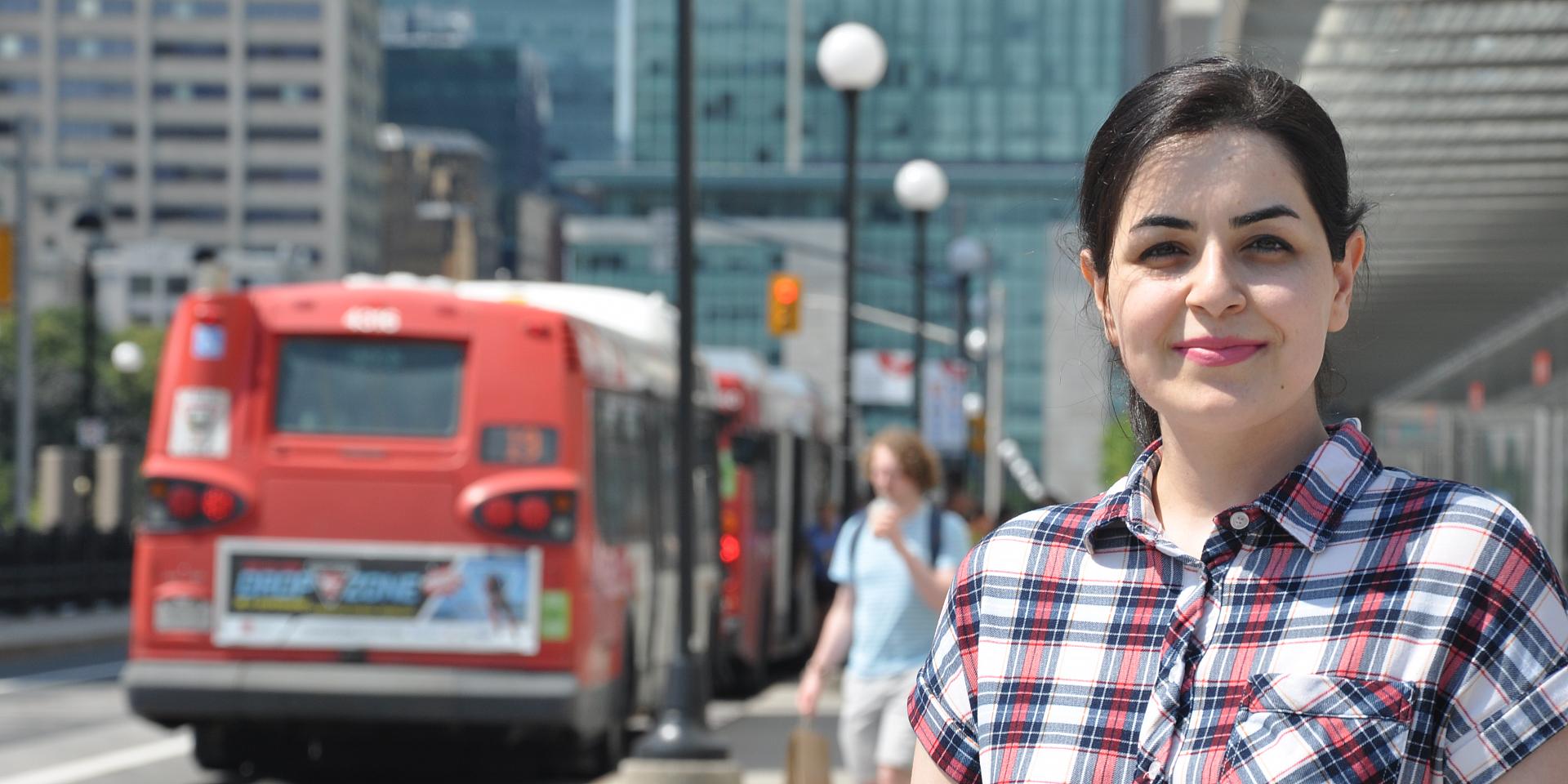 student in front of bus stop