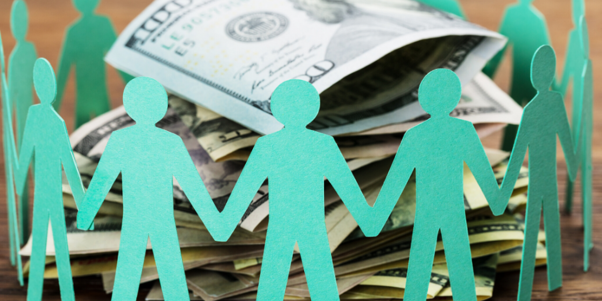 Paper cutout family surrounding money