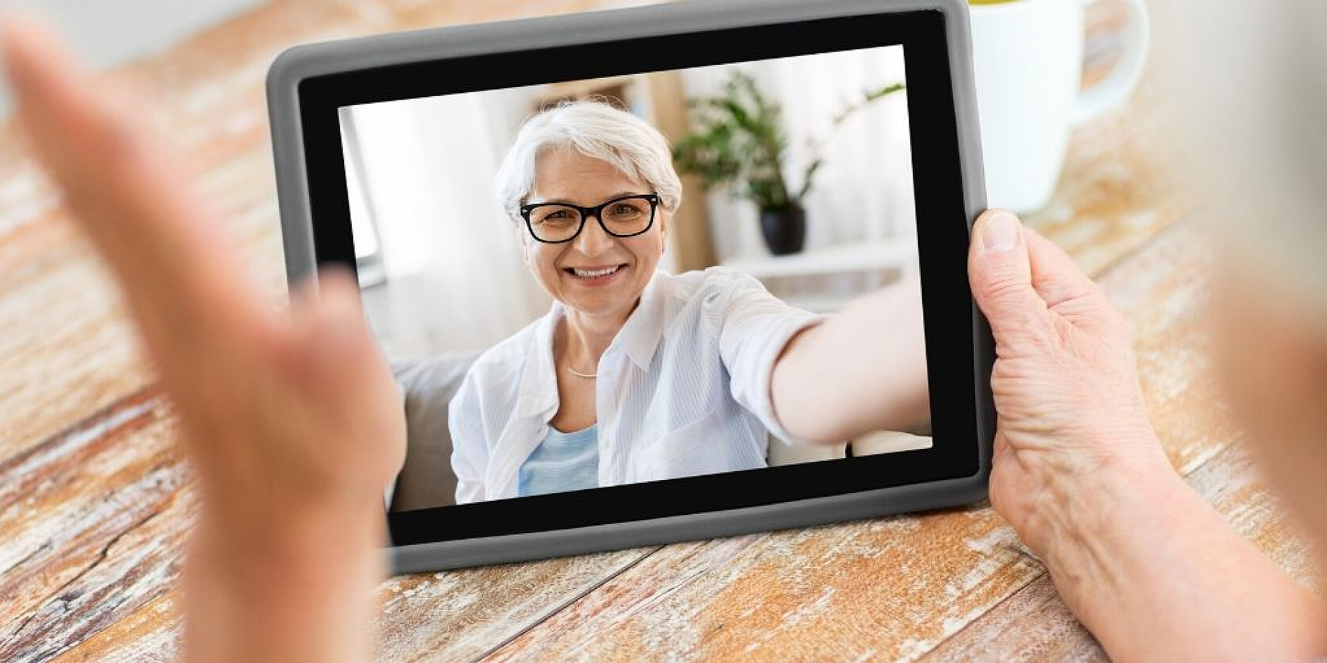 Video call on a tablet with older woman