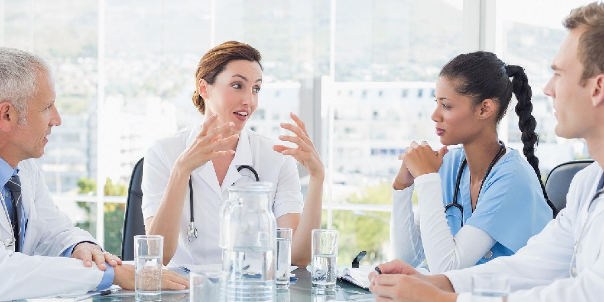 Medical professionals talking at a table