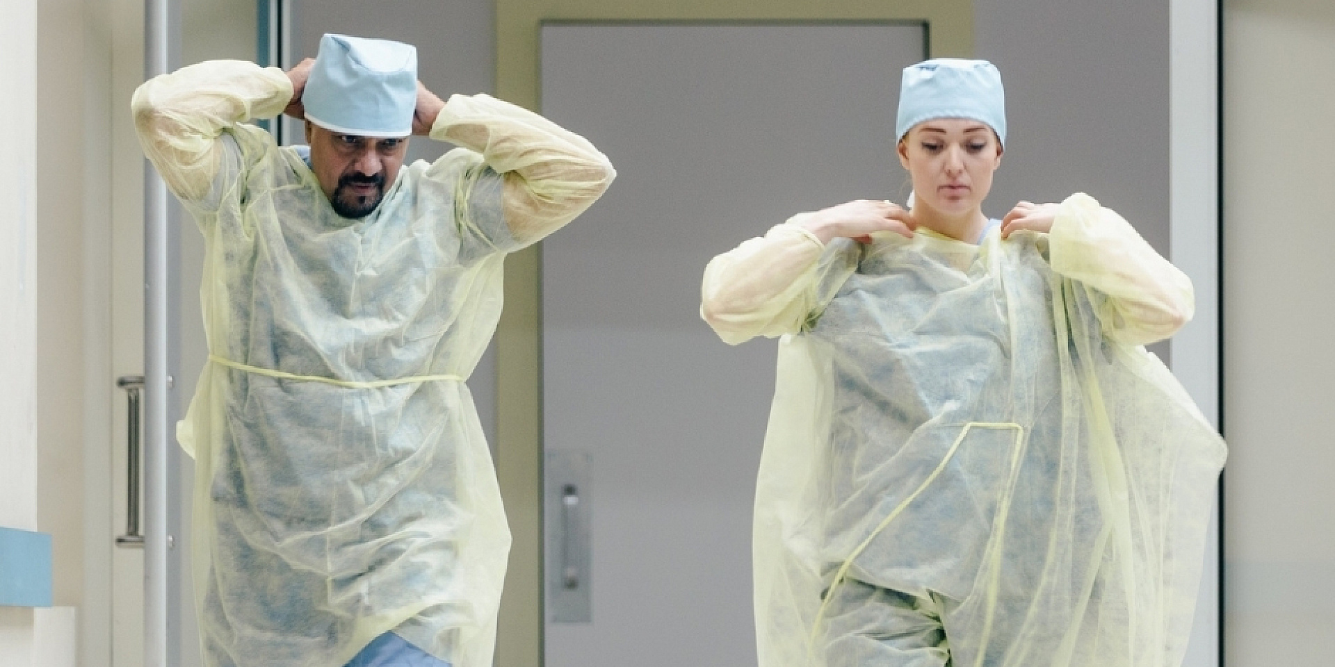 Doctors taking off protective equipment