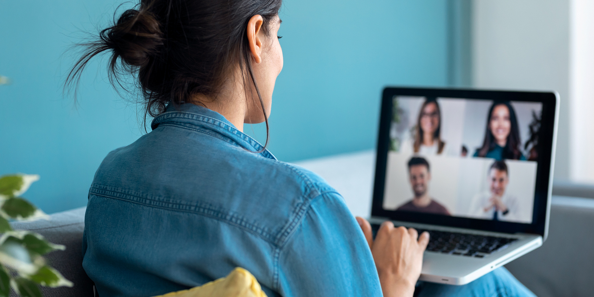 Young woman on a video call with four other people.